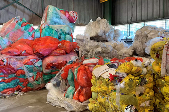 Nestlé, iQ Renew and Curbcycle kerbside trial: yellow (standard recycling), red (Coles) and green (Woolworths) bags contain soft plastics to be converted to feedstock for re-use .